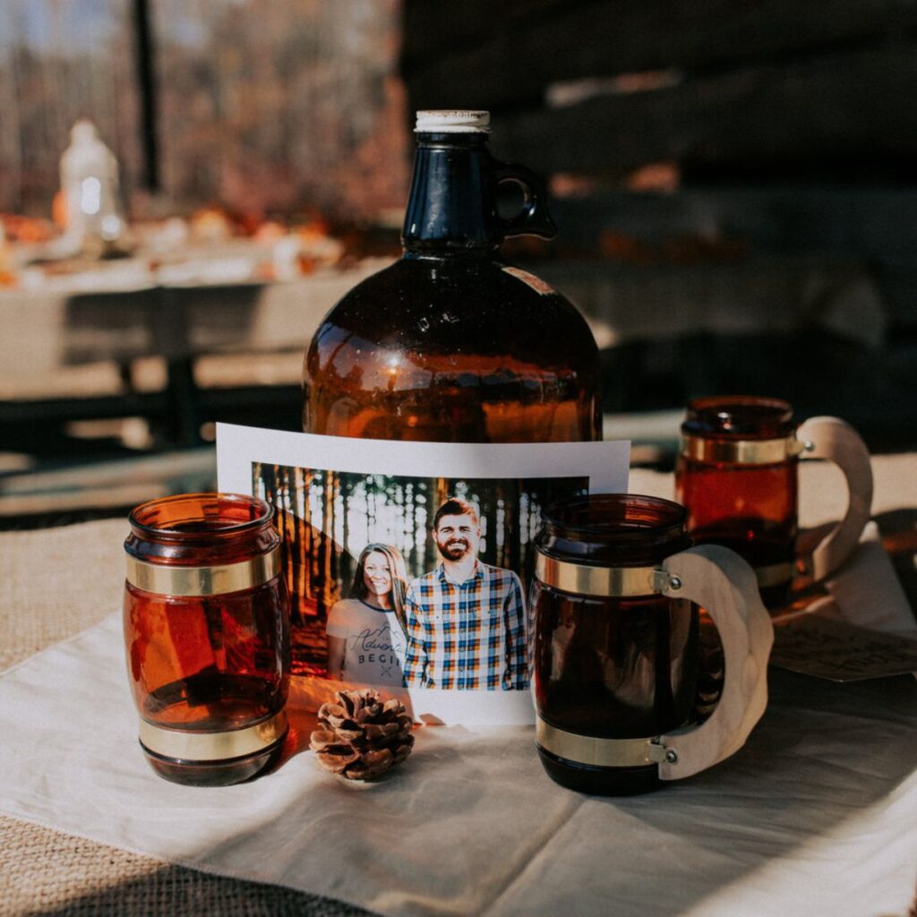 wedding decorations on a table that include an antique jug and glasses