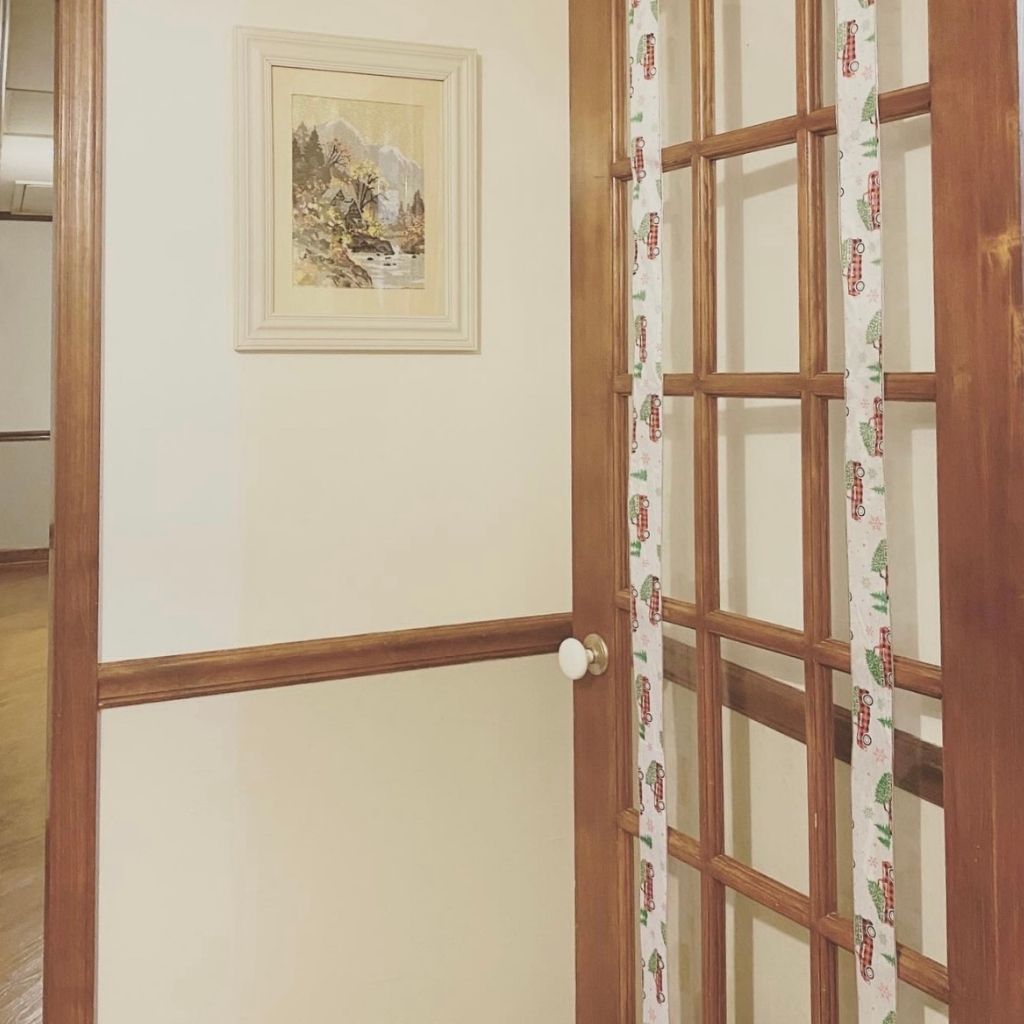 french door with glass panes and two pieces of ribbon hanging from the door
