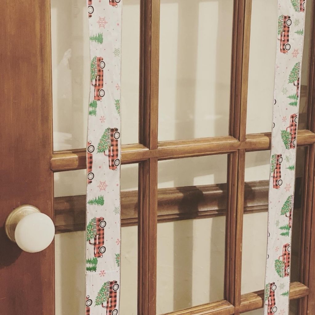 two pieces of ribbon on door with glass panes