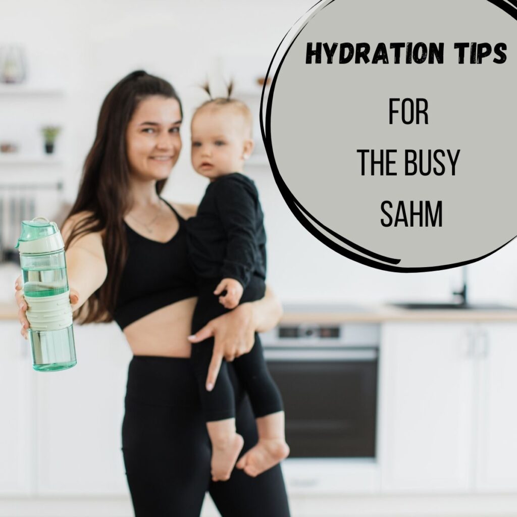 mom holding a toddler in one hand and a water bottle in the other