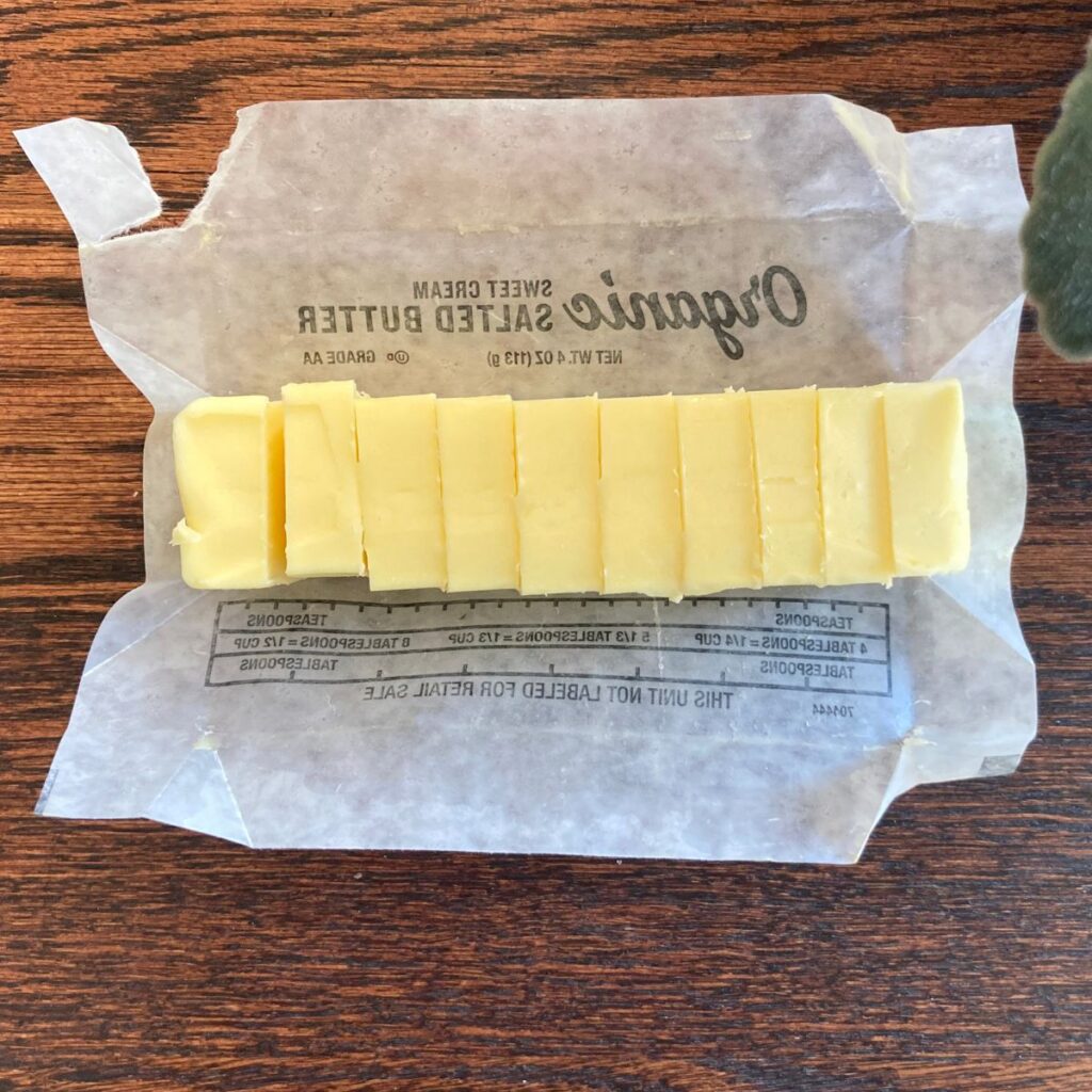 top down photo of a stick of organic, grass fed butter sliced in pieces