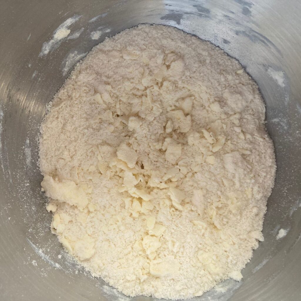 flour, butter and honey mixed together in a mixing bowl